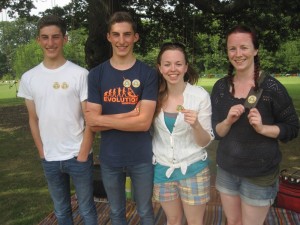 picture of four people under a tree 